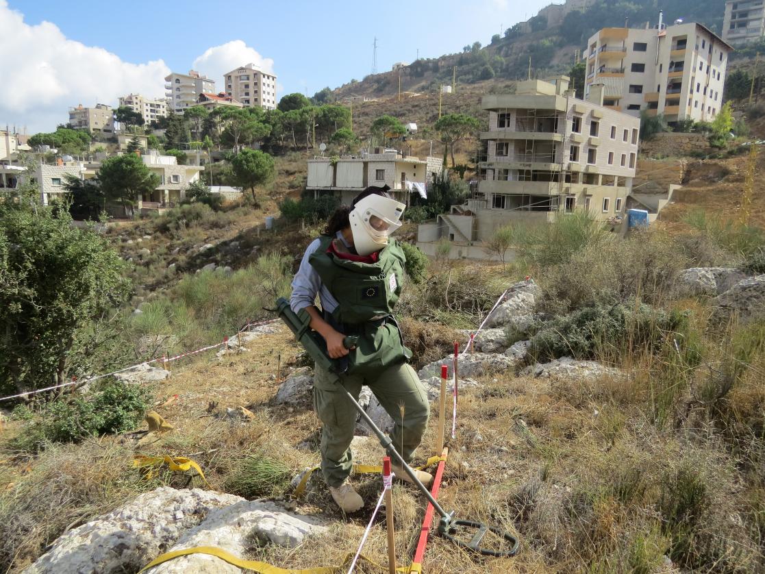 DCA Female deminer using the Vallon detector to locate land mines