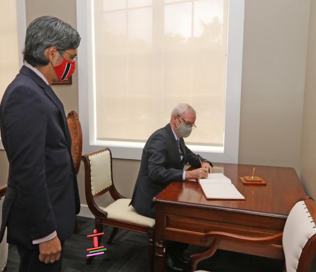 Ambassador Cavedish signs guest book at Ministry of Foreign and CARICOM Affairs