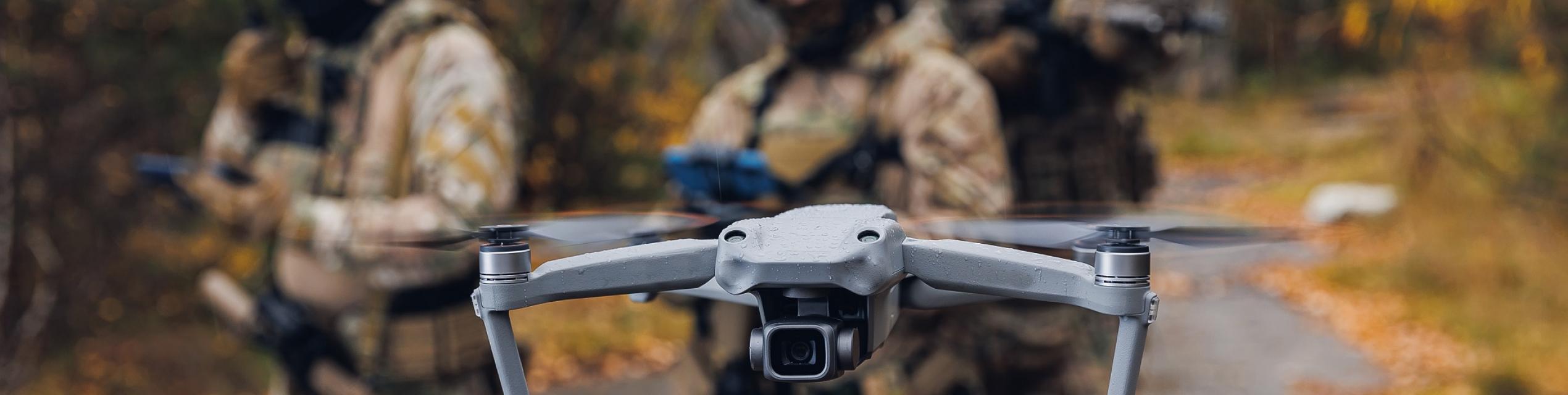 Modern army soldiers using aerial drone for artillery guidance