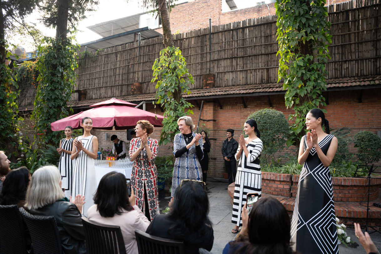 Models and designers walk the runway.