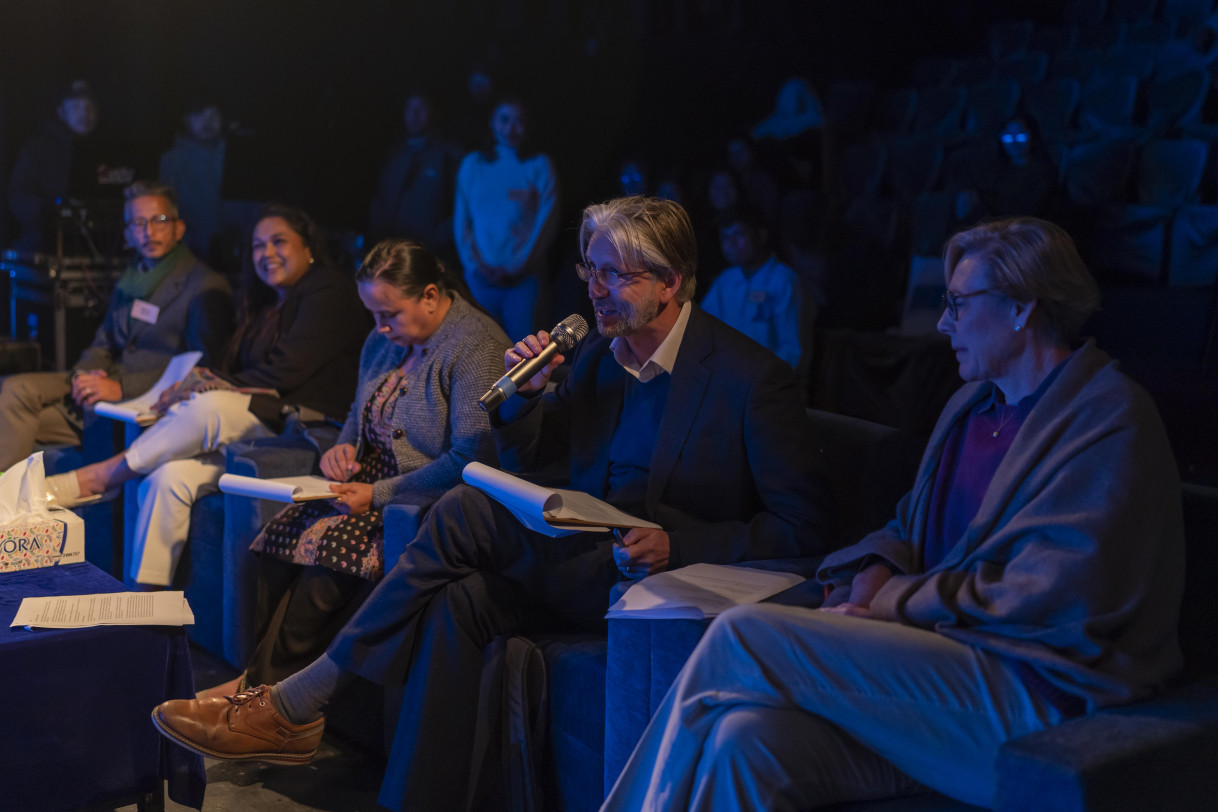 A member of the jury speaks to a speaker.
