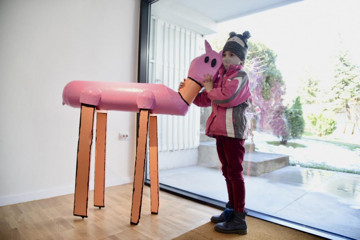 a girl posing with an sculpture 