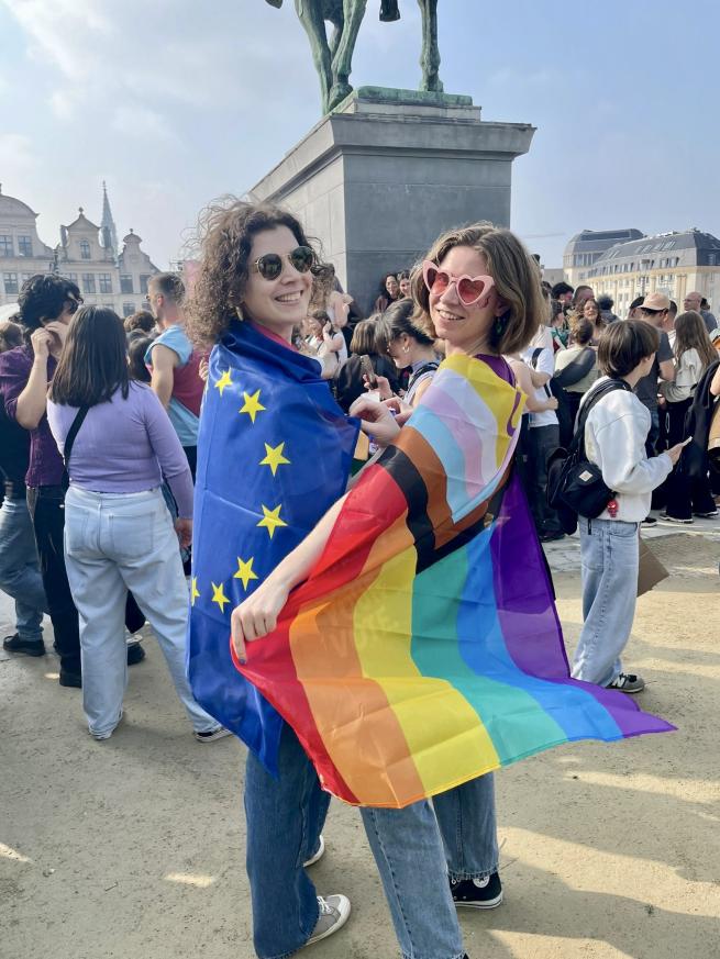 Two girsl with EU flag and Progress Pride flag