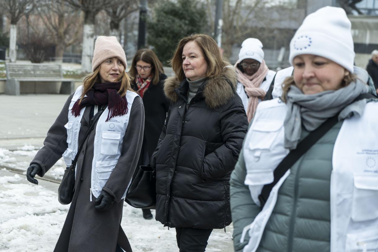 Chief Observer Nathalie Loiseau walking outside with observers