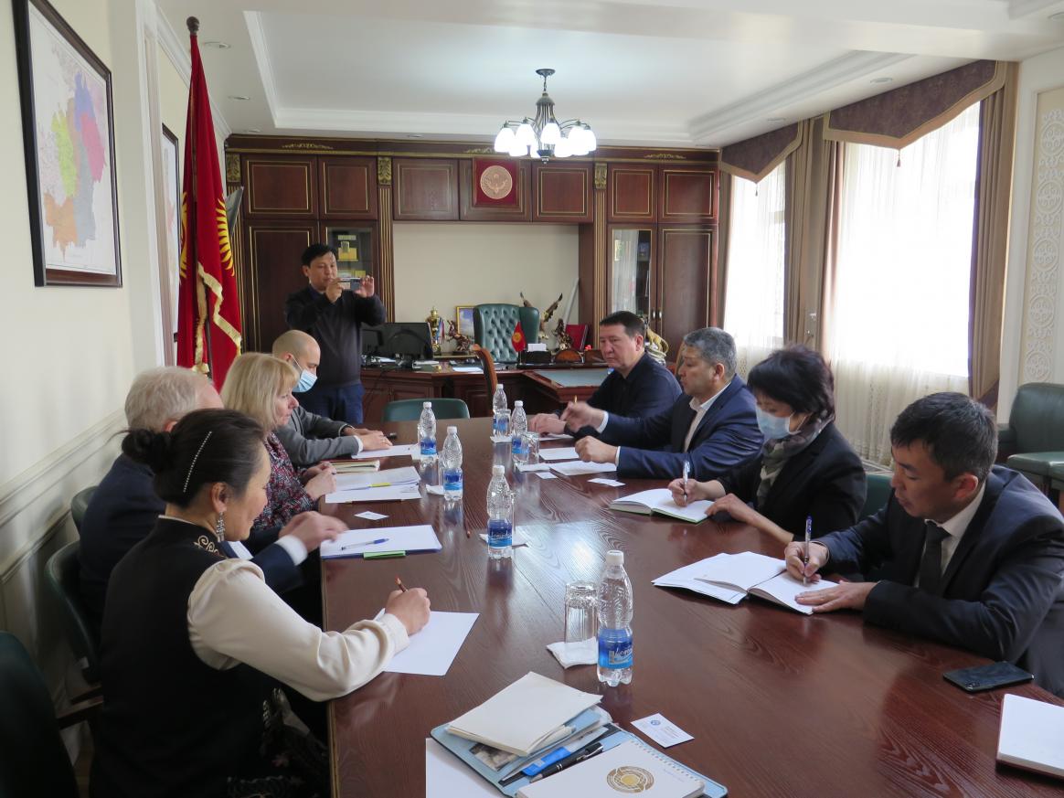 Group of people on two sides of the table.