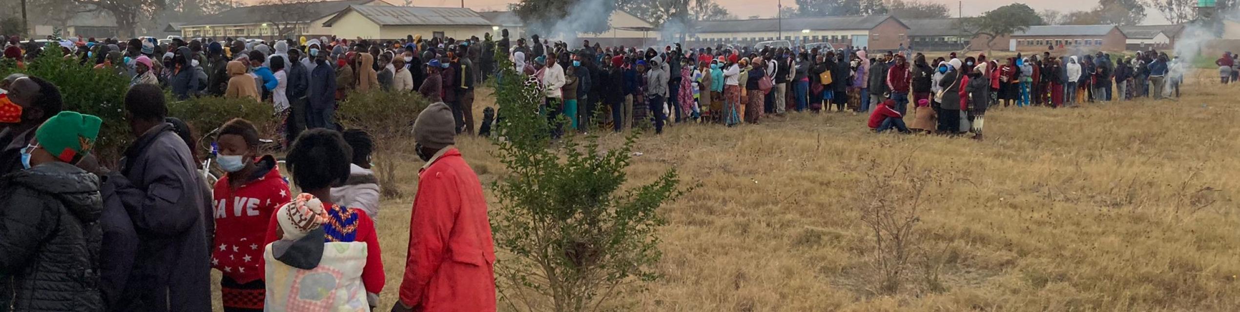 people queuing outside a voting station