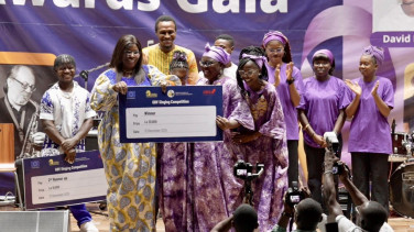 Gender Minister, Dr. Mahoi presents the award to Lyrical Three, winners of the competition
