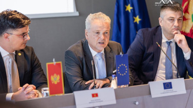 Ambassador Sattler sitting and speaking during the event