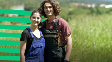 Two people standing in the field