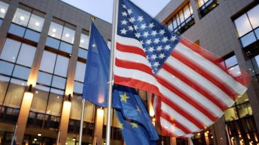 The European Union and United States flags wave.