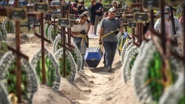 Image of people in a graveyard in Bucha for massacre victims. 