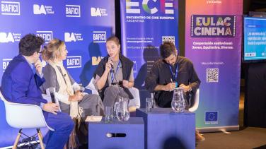 Filmmakers discuss their craft on a stage at a festival.