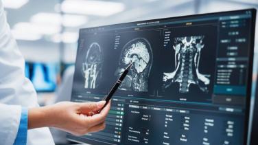Technician examines a medical image.