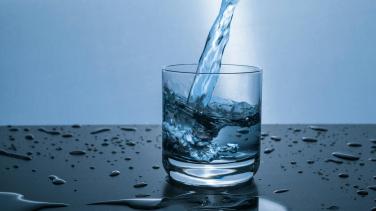 A glass of water getting filled