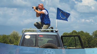 Civilian mission car with EU flag on a clear landscape