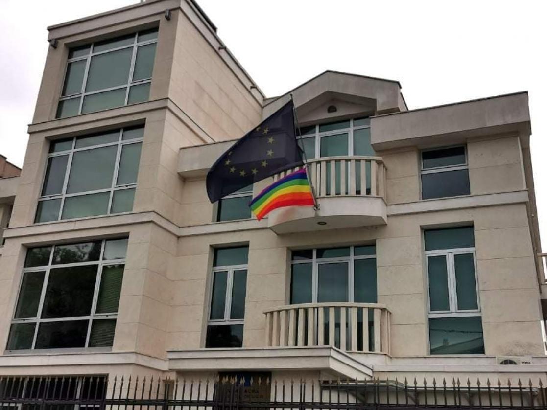 House with two flags a EU flag in black and a LGTBIQ+ flag