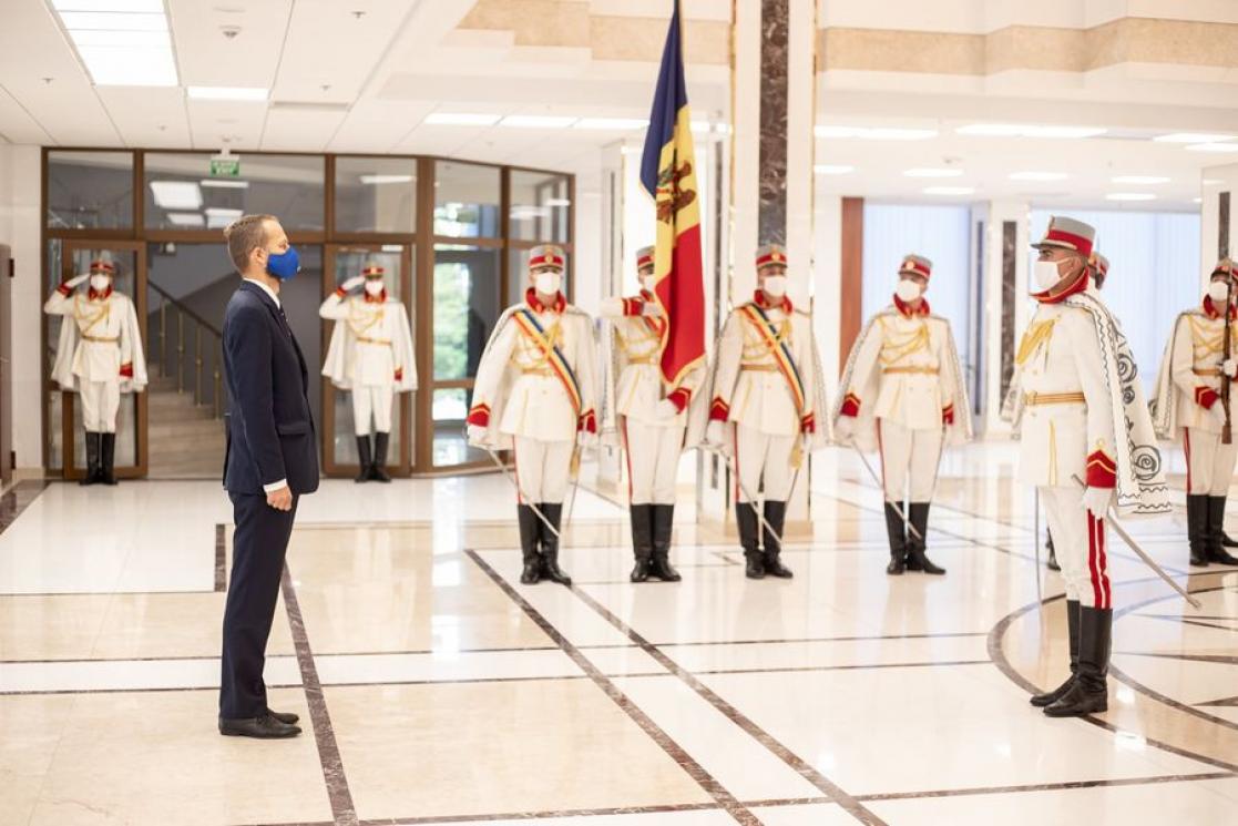 Man in suit greeting a group of people