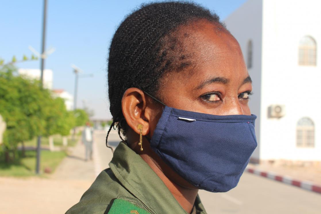 Woman posing in profile wearing sanitary mask