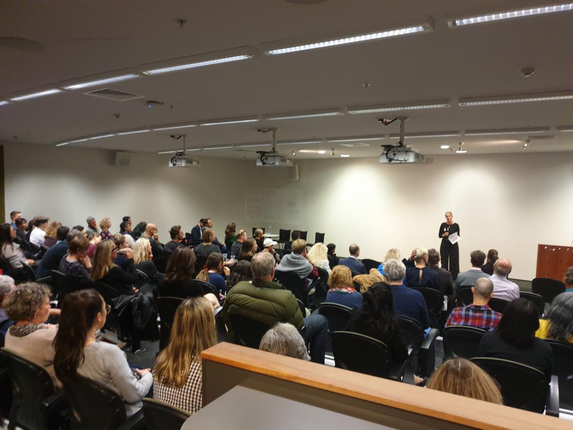 Woman giving a speech in front of an audience
