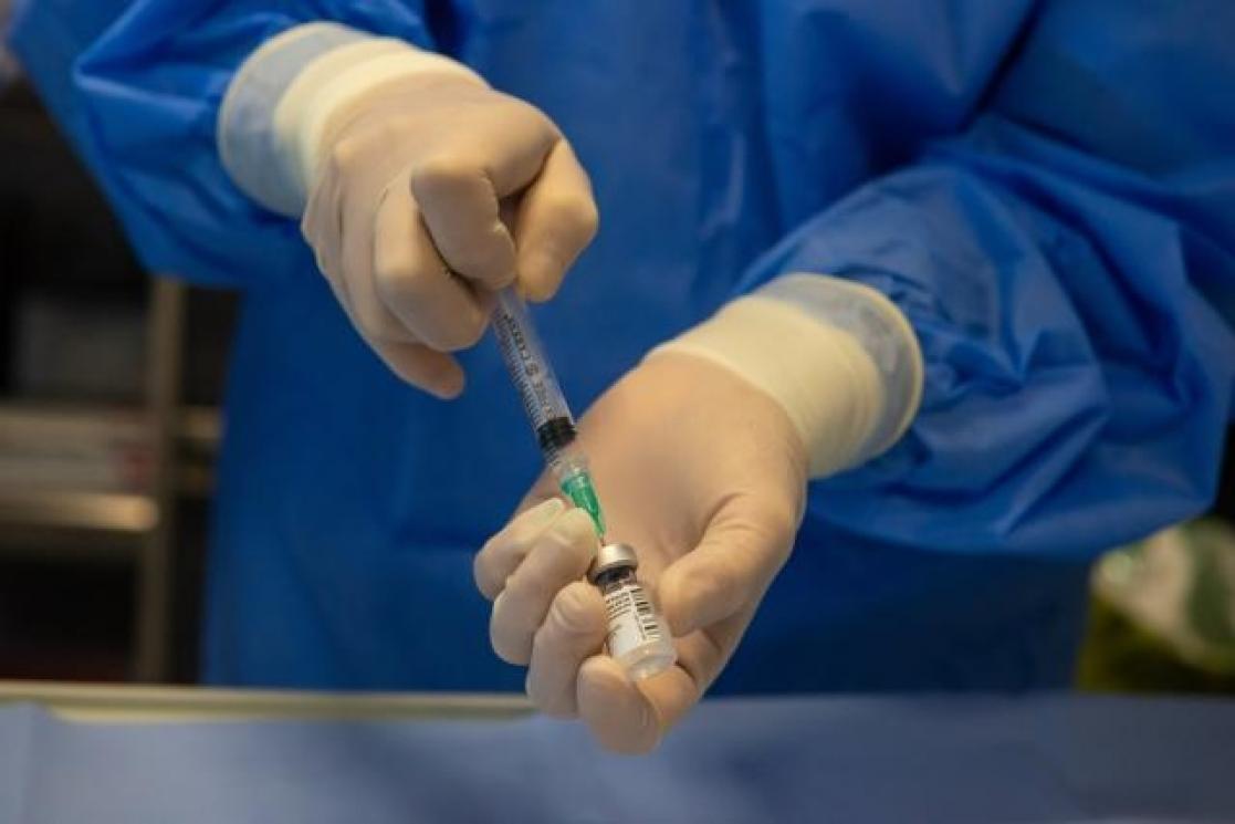 hands with a vaccine 