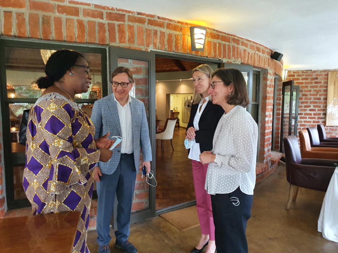 Three women and a man talking
