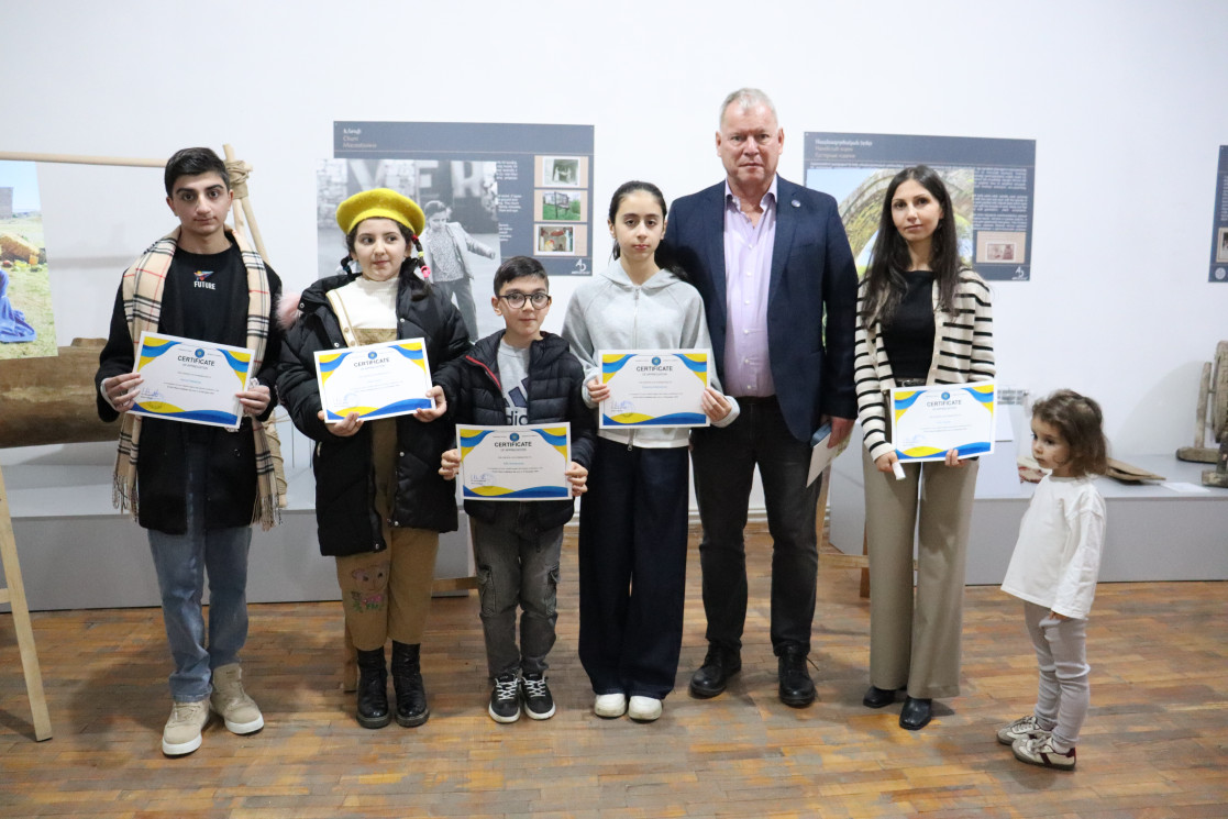 The young artists with their certificates together with the Head of Mission.
