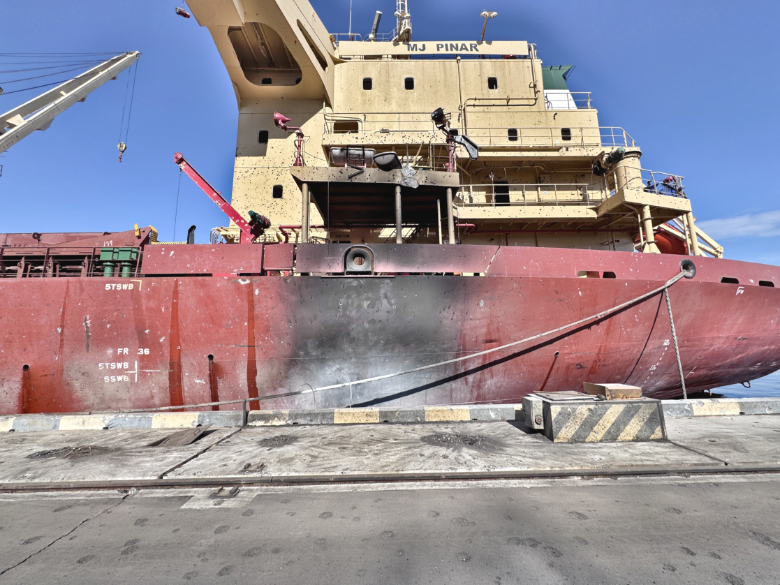 A burned out grain ship dockside in Ukraine.