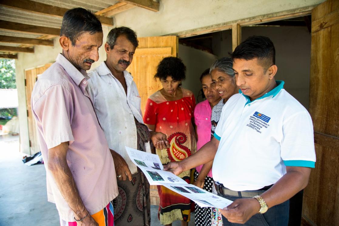 Group of people reading an information leaflet