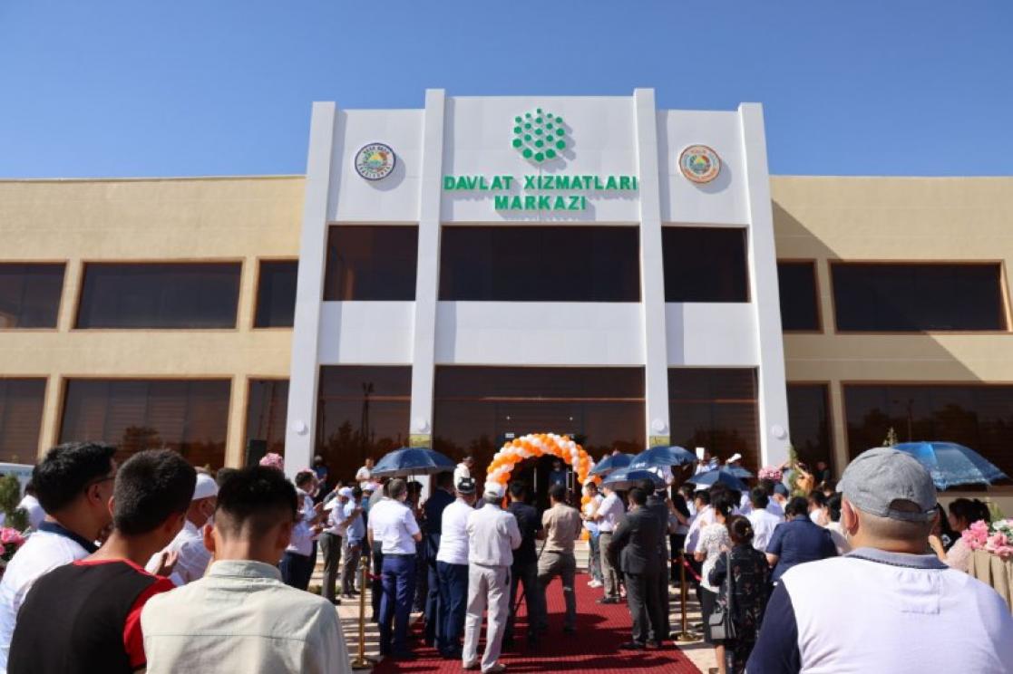 People waiting in front of a big building