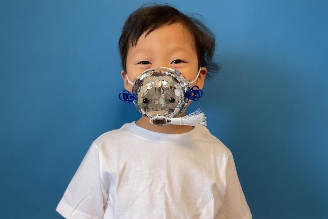 Kid with a plastic object on his face