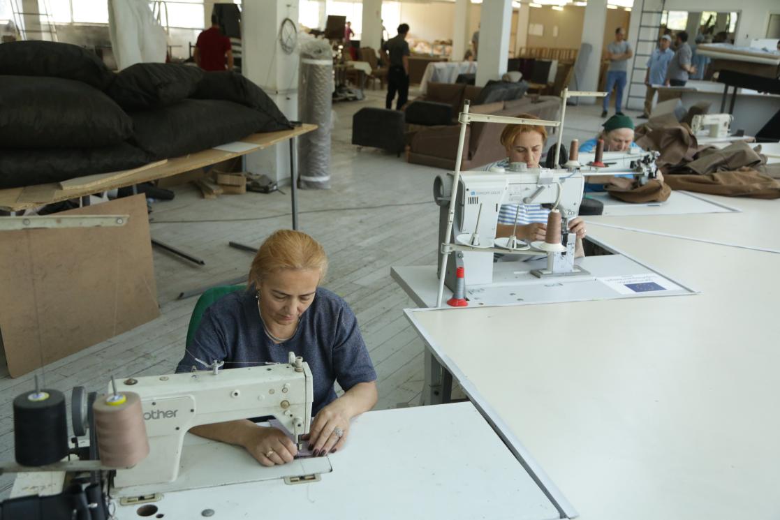 Women sewing with machines in a factory