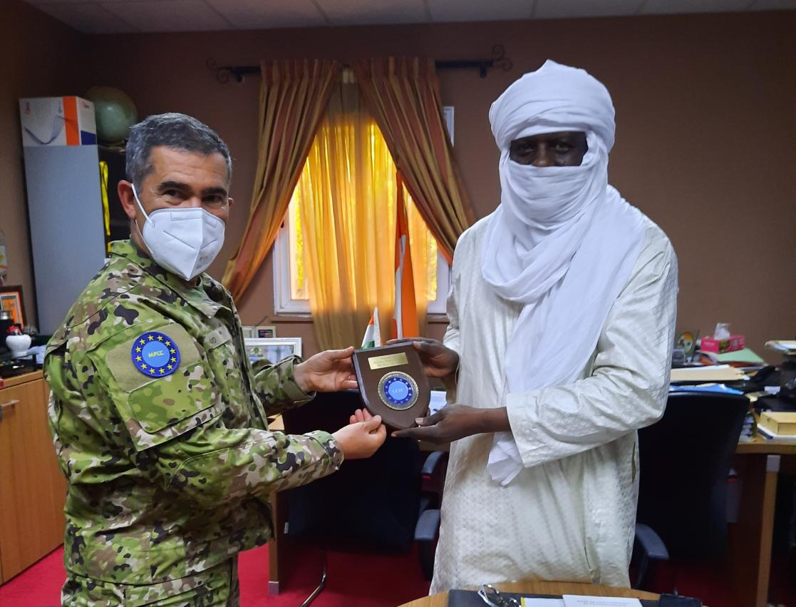 Two people holding a commemorative plaque