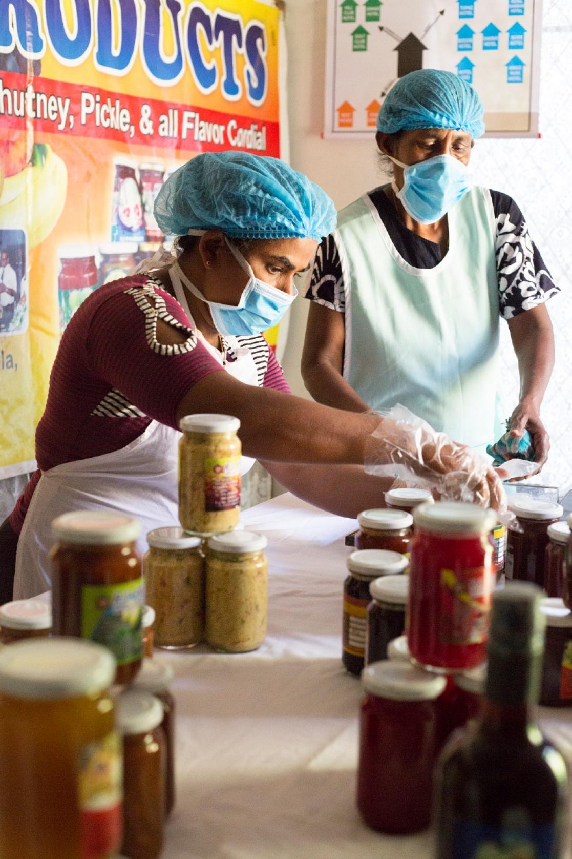 Women closing canning jars