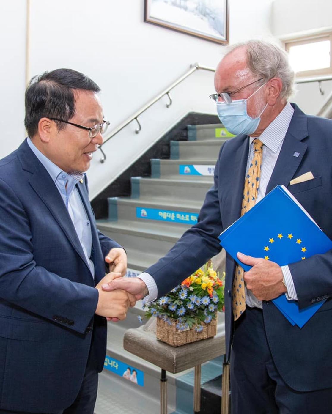 Two men greeting each other shaking hands
