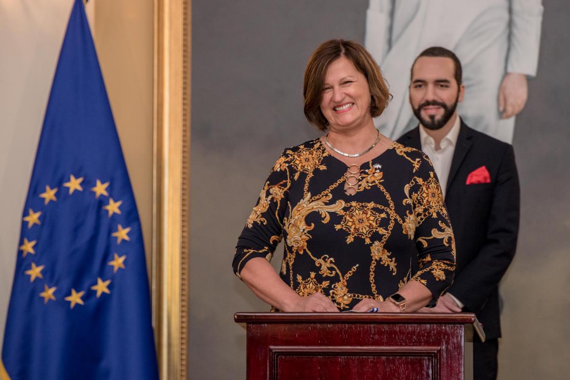 a woman giving a speech with Bukele president of El Salvador 