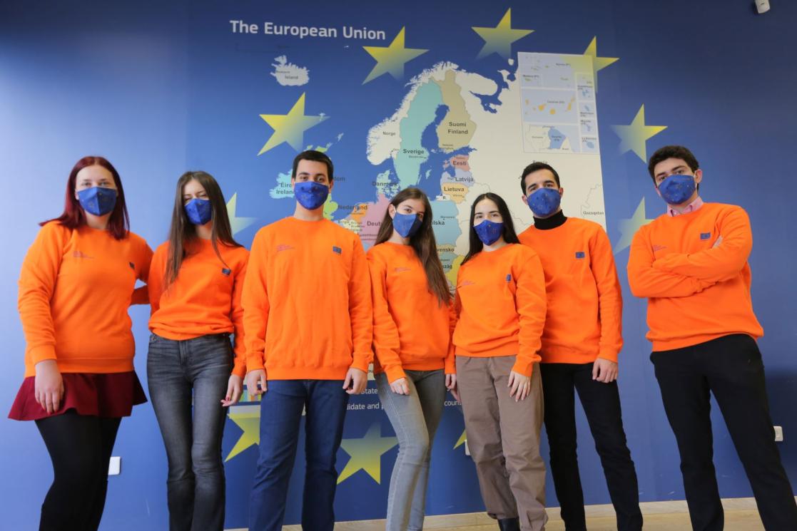 Group of people in orange hoodies