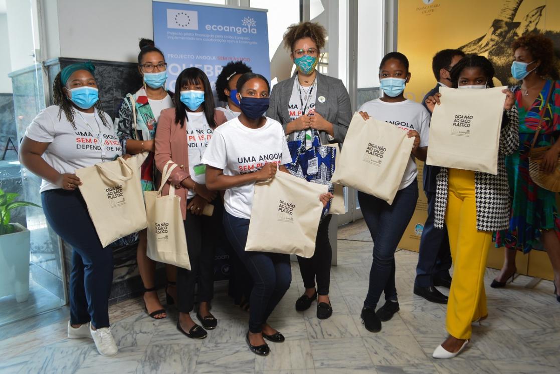Group of women holding some material bags