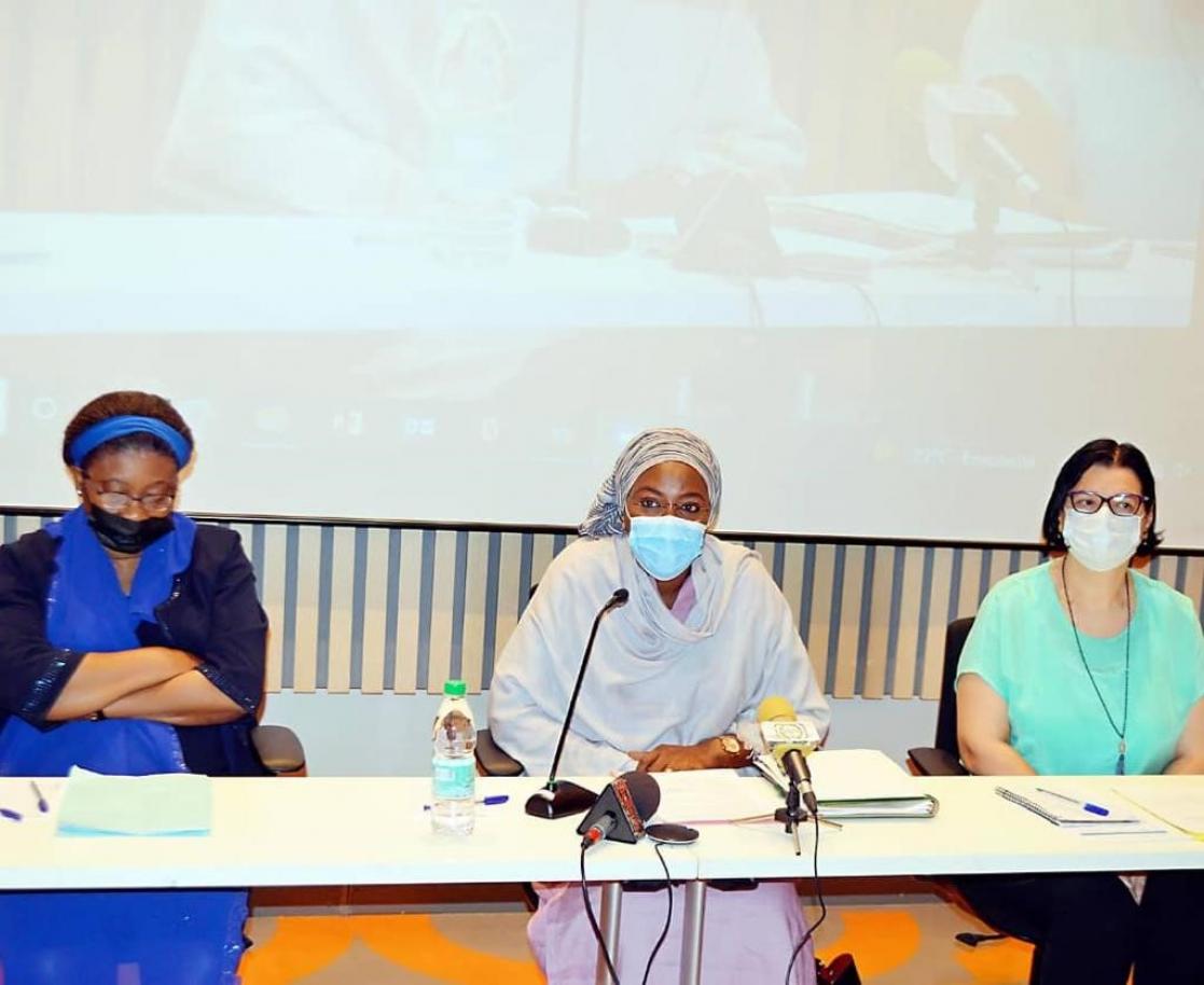 Two women and a man during a presentation at a round table