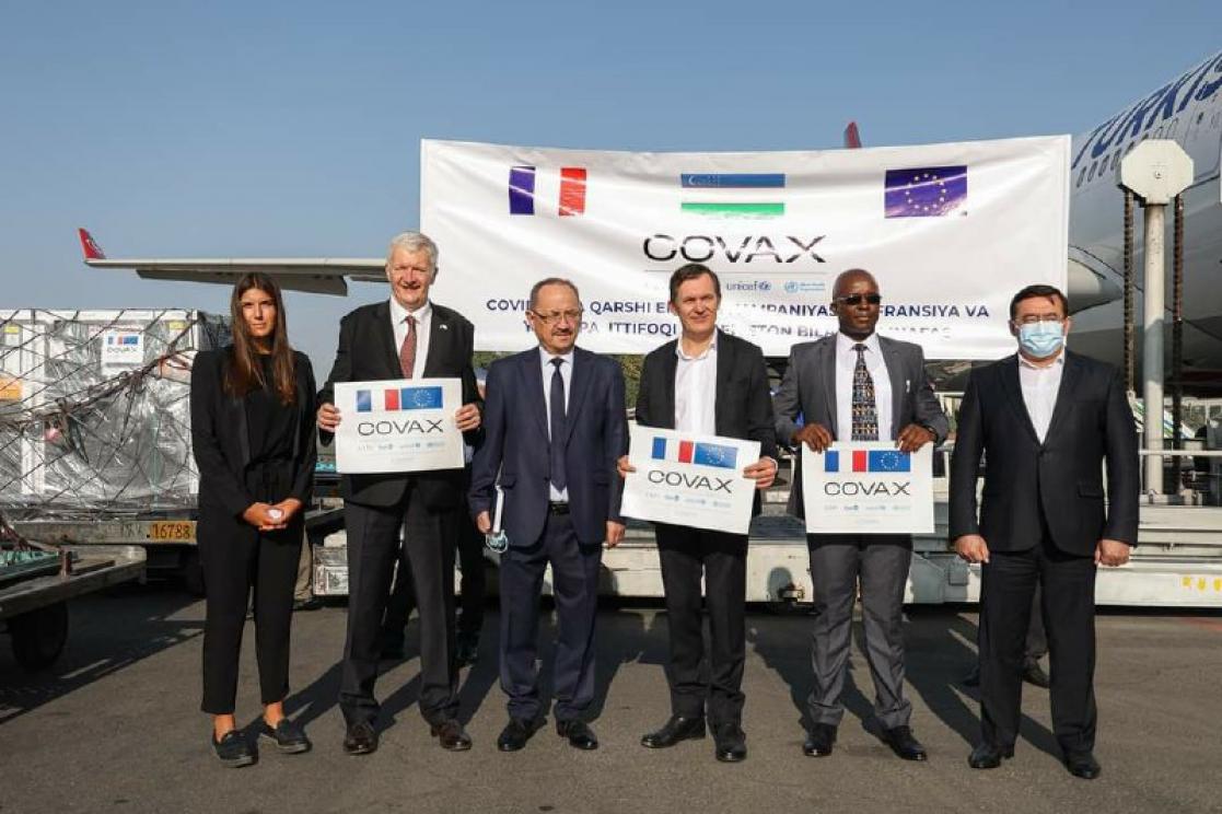 Five men and a woman holding banners