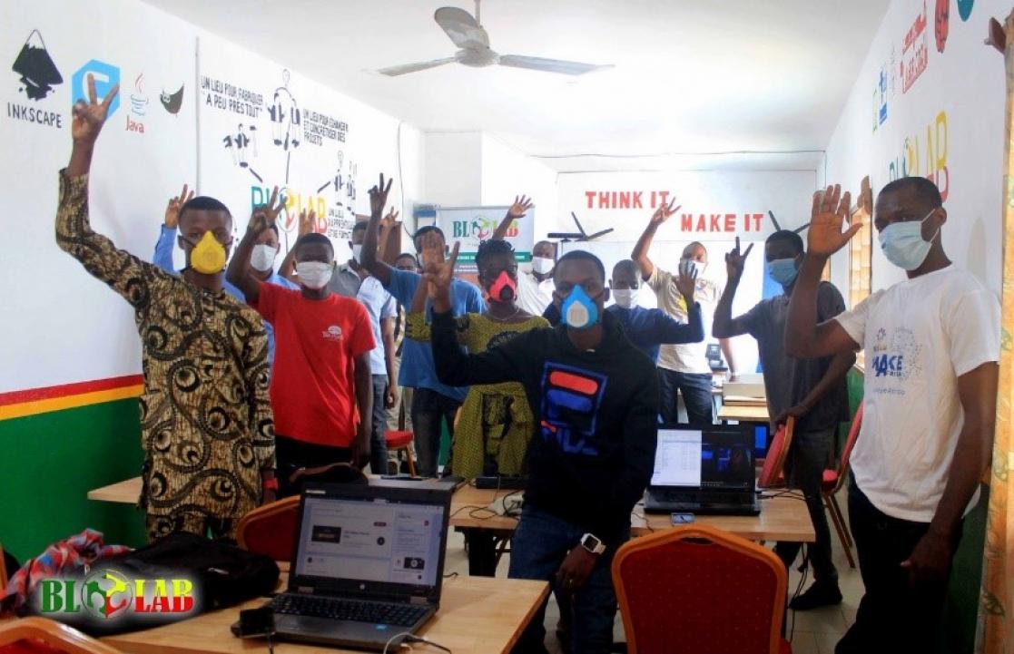Young men raising their hands in a classroom