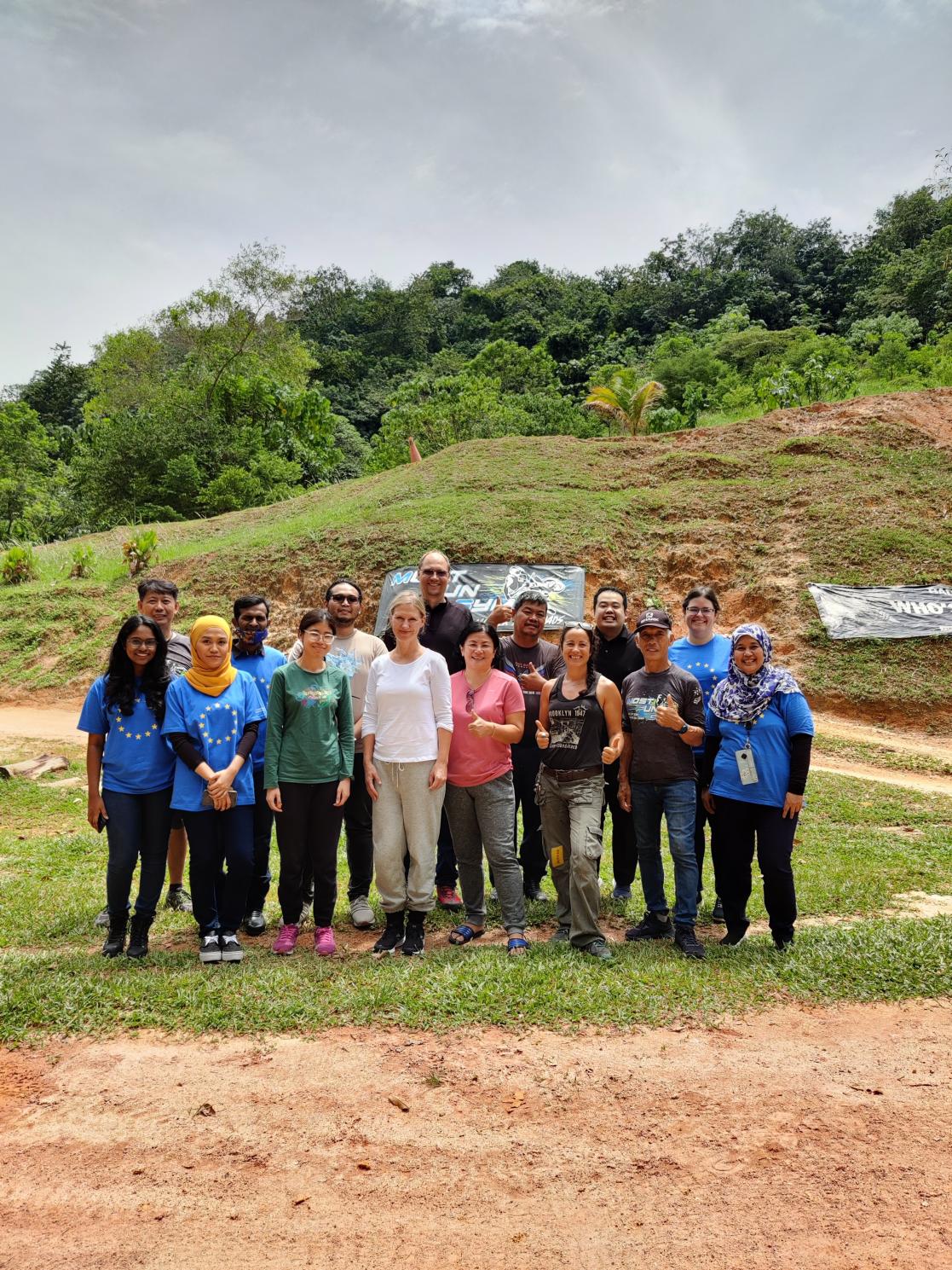 Group of people posing in the field