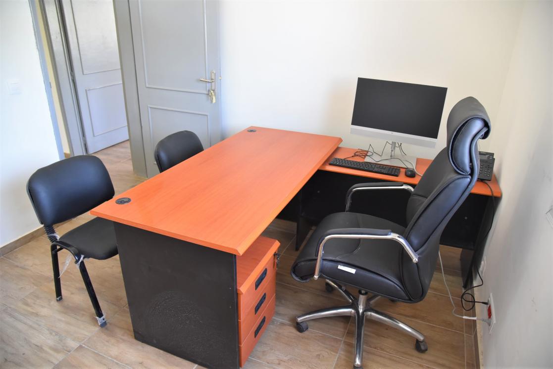 Office with a table, three chairs and a computer