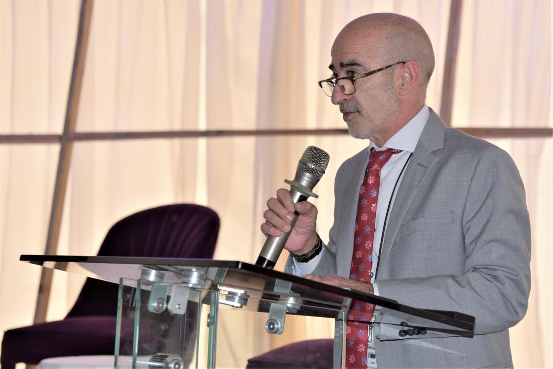 Juan Jose Villa Chacon speaking into a microphone