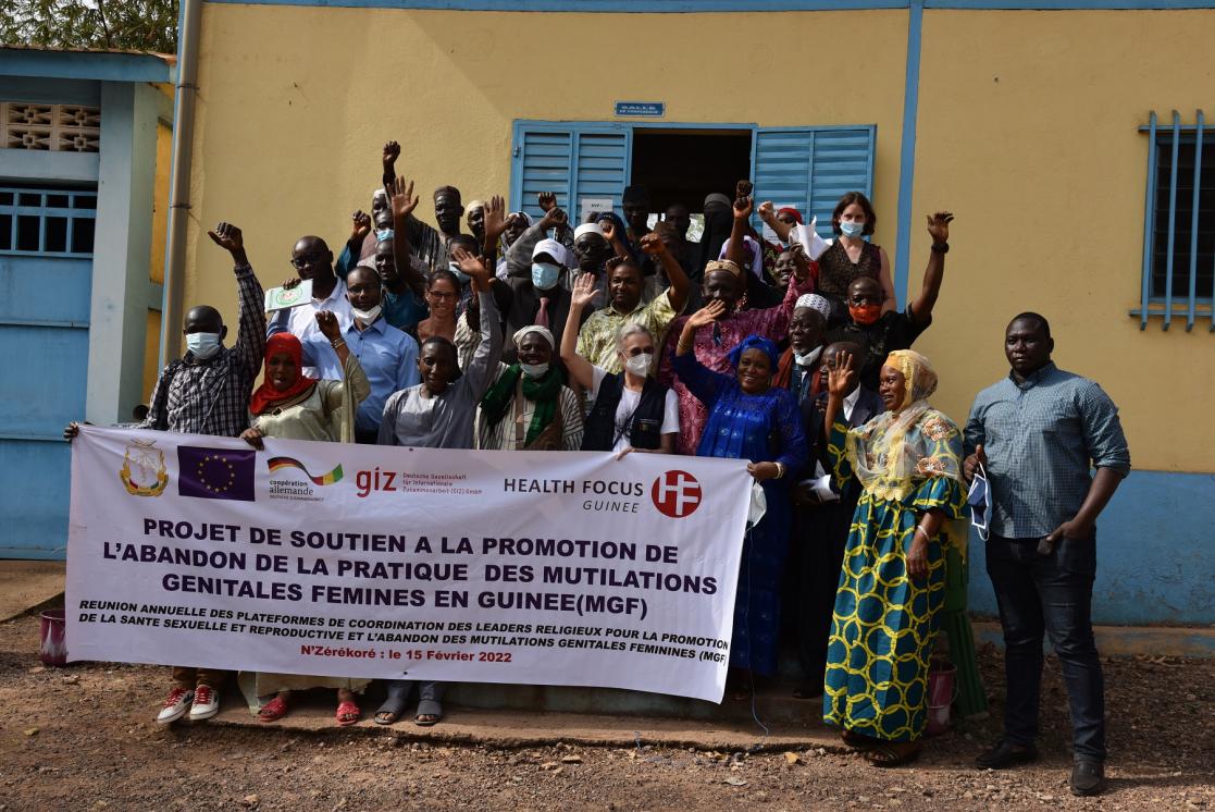 Group of people holding a banner