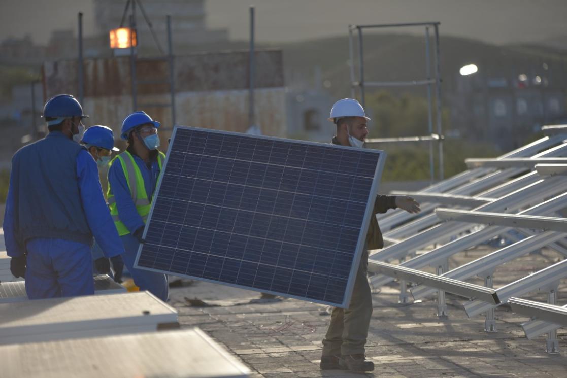 Man carrying a solar panel 