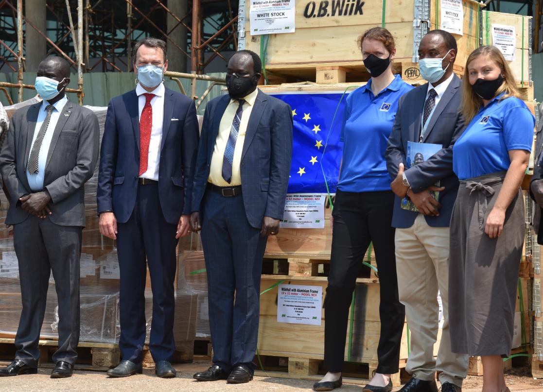 Group of people with boxes of material in the background