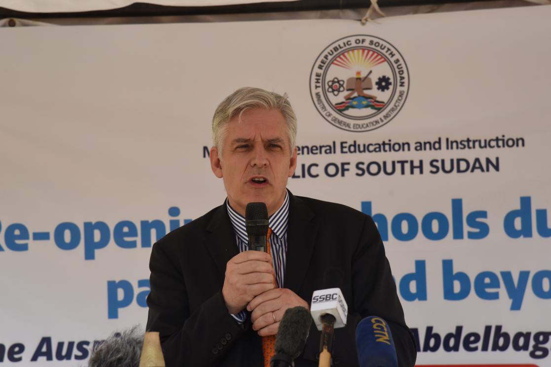 Ambassador Christian Bader speaking into a microphone