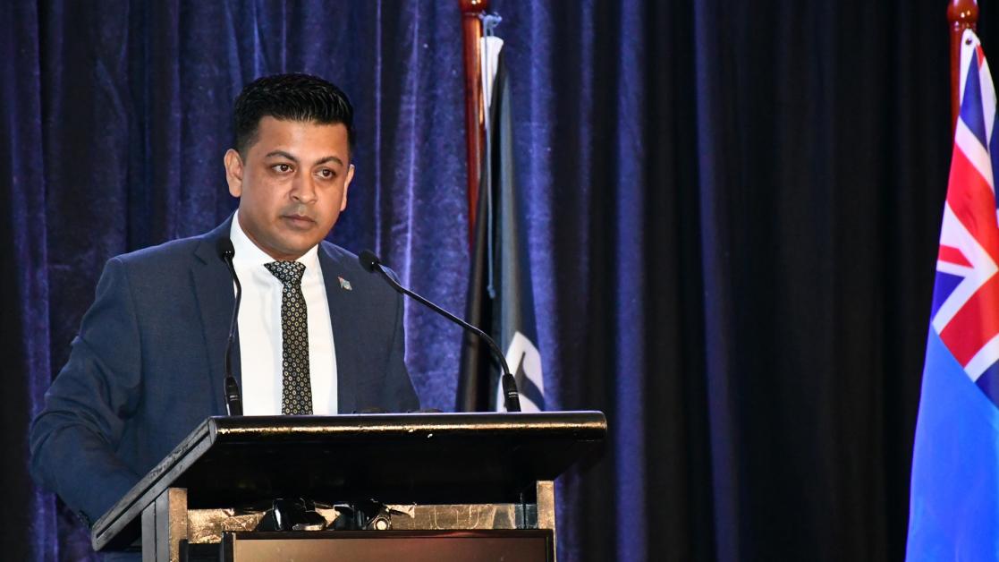 Man speaking at a lectern