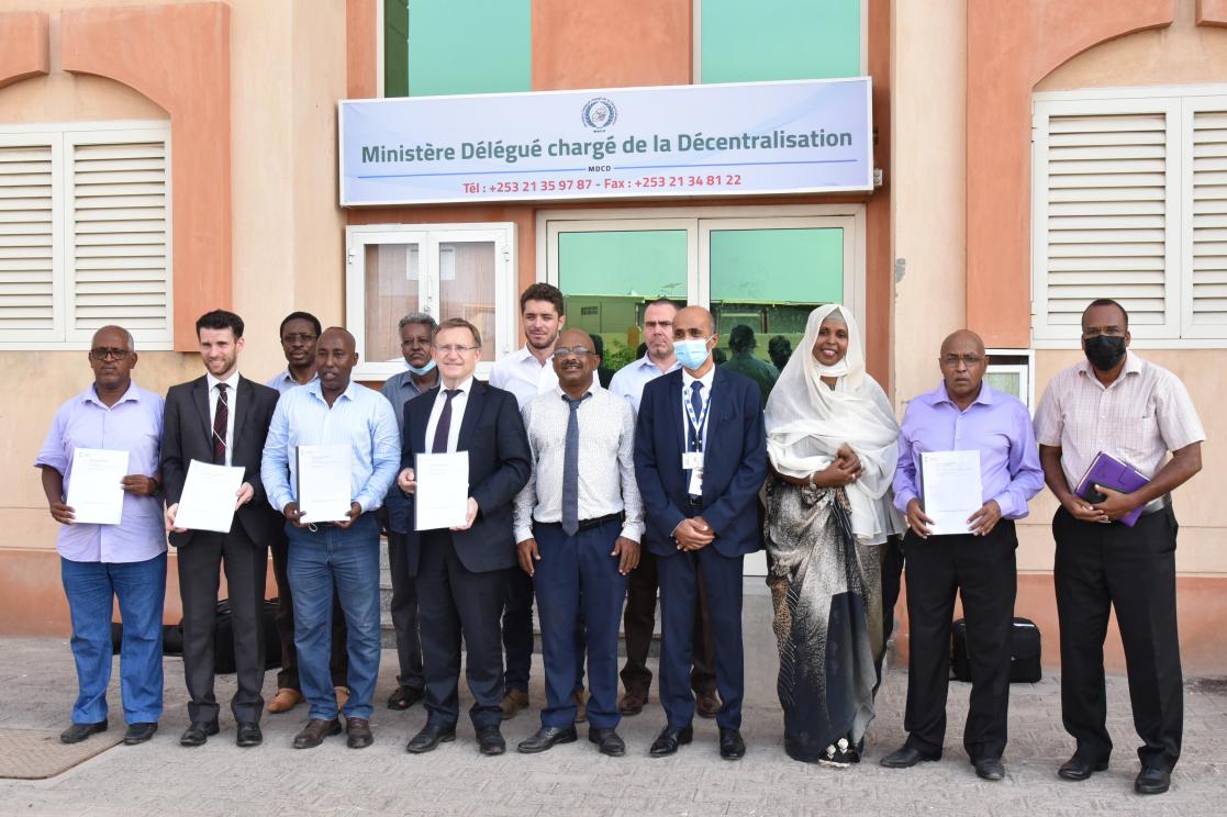 Group of people posing with some documents