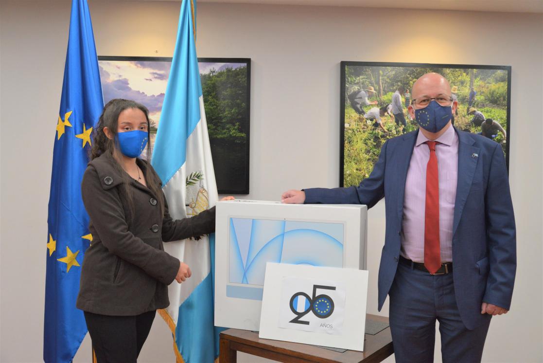 Man and woman posing next to a box